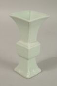 A CHINESE CELADON MINIATURE PORCELAIN GU VASE, with six-character mark, 12.2cm high.