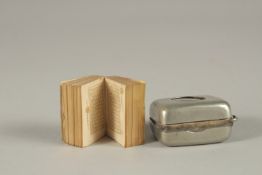 A VERY RARE MINIATURE QURAN IN ORIGINAL METAL CASE, with magnifier, inscribed in gold.