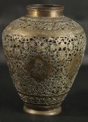 A LARGE ISLAMIC PERSIAN OPENWORKED BRASS VASE, engraved with portraits and animals, 30cm high.
