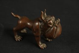 A BRONZE OKIMONO OF A DOG.