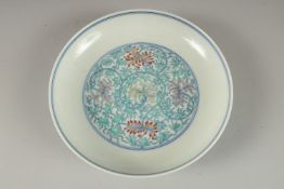 A CHINESE POLYCHROME PORCELAIN FLORAL DISH, the base with six- character mark, 16cm diameter.