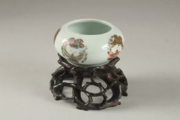 A CHINESE PORCELAIN BOWL ON A CARVED HARDWOOD STAND, the bowl painted with butterflies and bearing