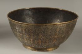 A FINELY ENGRAVED 19TH CENTURY PERSIAN QAJAR BRASS BOWL, 25cm diameter.
