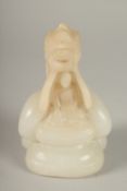 A CARVED ALABASTER BUDDHISTIC FIGURE, with seated buddha and overarching dragon, 14cm high.