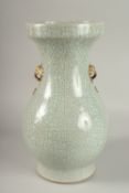 A LARGE CHINESE CELADON CRACKLE GLAZE PORCELAIN VASE, with gilded win handles, 39cm high. Povenance:
