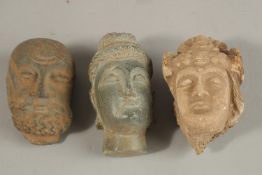 A GROUP OF THREE INDIAN GANDHARA CARVED HEADS, buddha 9.5cm high, (3).