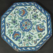 AN ISLAMIC MARKET FRENCH OR ITALIAN GLAZED POTTERY OCTAGONAL TILE, painted with floral motifs,