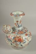 A JAPANESE IMARI PORCELAIN KENDI, painted with pomegranate and flora with gilt highlights, 19.5cm