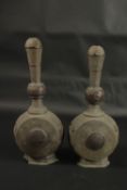 A RARE PAIR OF 18TH CENTURY PERSIAN COPPER MOUNTED LEAD BOTTLES, with openworked panels, 37cm high.