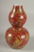 A CHINESE RED GROUND PORCELAIN DOUBLE GOURD VASE, 23cm high.