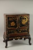 A FINE JAPANESE MEIJI PERIOD BLACK AND GILT LACQUERED CABINET, raised on stand, the two doors