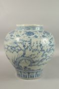 A LARGE CHINESE BLUE AND WHITE PORCELAIN JARDINIERE, painted with trees and clouds, 34cm high.