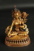 A FINE GILDED BRONZE FIGURE OF A SEATED DEITY, on a lotus base, the reverse inscribed, 15.5cm high.