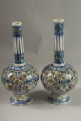 A FINE PAIR OF 19TH CENTURY PERSIAN QAJAR GLAZED POTTERY BOTTLE VASES, 32cm high.