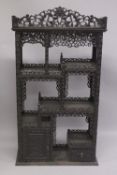 A FINE CHINESE CARVED OPENWORK HARDWOOD DISPLAY CABINET, 154cm high, 8cm wide, 36cm deep.