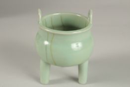 A CHINESE CELADON GLAZE PORCELAIN TRIPOD CENSER, 13cm high.