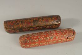 TWO LARGE 19TH CENTURY INDIAN KASHMIR LACQUERED PEN BOXES, largest 31cm long, (2).