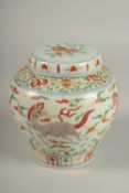 A CHINESE DOUCAI PORCELAIN JAR AND COVER, painted with horses, 16cm high.
