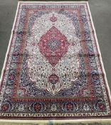 Ivory ground Persian carpet with traditional medallion design 230cm by 160cm