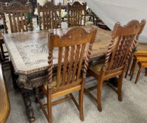 Late Victorian oak dining table with carved top on double bulbous baluster supports on carved