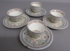 Set of 4 Chinese tea bowls with saucers to match, flowered design, single gold character to centre