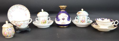 Pair of Continental Meissen style porcelain chocolate cups, covers and stands, hand-painted with