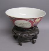 Chinese bowl with four white panels with landscapes between deeper pink and flower design, plain