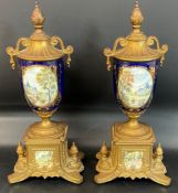Pair of decorative porcelain & metallic lidded urns