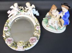 Sitzendorf floral encrusted mirror surmounted by cherubs & 20th century Continental figure group