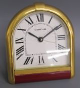Cartier travel alarm clock with arched gilt metal frame and red laquer below  - sapphire studs to