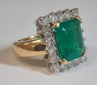 Impressive 18ct gold emerald & diamond cluster ring with central rectangular emerald approximately