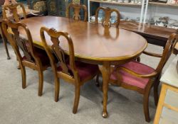 Draw leaf dining table on cabriole legs (207cm by 106cm) with a set of six Queen Anne style chairs