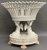 Ceramic table centre piece in the form of a basket supported by two putti (damage to top of