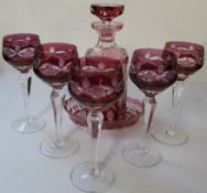 Cranberry patterned design decanter with dish and five wine goblets