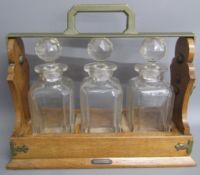 Betjemann 'The Tantalus' containing 3 decanters (one damaged and missing key)