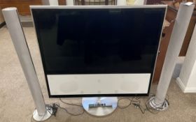 Bang & Olufsen TV with floor standing speakers & a remote control