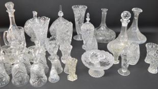 Large selection of cut glass including ships decanters, vases, bells etc.