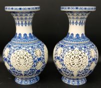 Pair of Chinese reticulated blue & white porcelain baluster vases with cylindrical inserts, 29cm