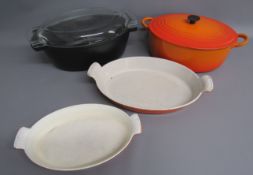Flame orange Le Creuset oval casserole dish - France and Belgium shell handle cooking dishes - Pyrex