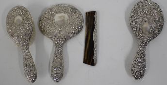 Silver part dressing table set including round mirror, comb, and brush plus additional oval