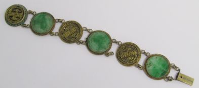 Chinese yellow metal bracelet set with jade discs approx. 2cm dia. with carved design and piercing &