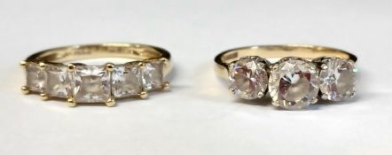 Two 14ct gold (585) cubic zirconia three stone rings, total weight 5.70g