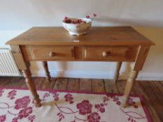 A contemporary pine two drawer side table, 102cm wide.