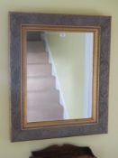 A contemporary bevelled edge mirror, 96 x 80cm.