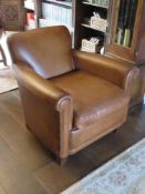 A single brown leather scroll arm chair