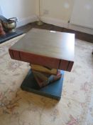 A contemporary side table fashioned in the form of stacked books, 42cm high.