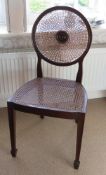 A single bergere mahogany framed chair raised over square tapering legs, a/f.