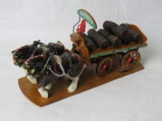 A ceramic horse and wooden cart figurine in the style of Melba ware.