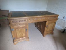 A light oak Victorian style kneehole pedastle desk,