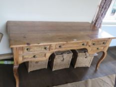 An impressive pine desk or side table having central frieze drawer flanked by drawers to each side,